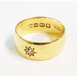 An 18ct. gold gypsy set tiny diamond ring
