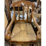 A 19th Century fruitwood framed scroll elbow chair with woven rush seat panel, set on cabriole