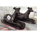 A pair of resin greyhound figurines with bronzed finish