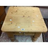 A 60cm modern pine coffee table with single drawer, set on heavy turned legs