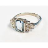 A marked PLAT Art Deco style ring, set with central oblong aquamarine and six flanking small