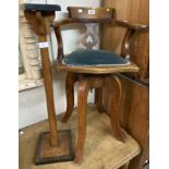 An old mahogany framed child's swivel action adjustable high elbow chair with upholstered seat