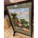 A vintage stained wood framed fire screen with decorative woold work panel under glass