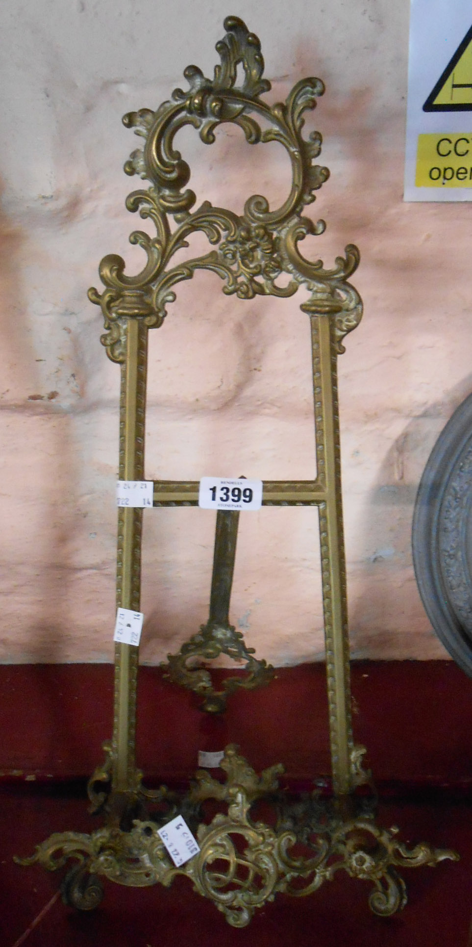 A vintage cast brass table easel with decorative Rococo styling