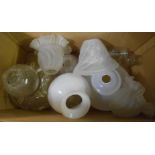 A box containing a quantity of oil lamp shades and chimneys