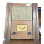 A 1940's utility valve radio with polished wood case