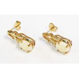 A pair of hallmarked 375 gold ear-rings, each set with oval milky opal and tiny diamonds - boxed