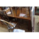 A retro stained rosewood effect extending dining table with two leaves and separate D-ends, set on