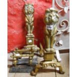 A pair of brass lion form fire dogs (one with arm missing) - sold with another cast iron and brass