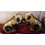 A pair of hollow cast pottery pug dog figurines - one a/f to leg