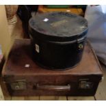 An old black japanned metal hatbox with brass name plaque and catch - sold with an old leather