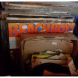 A crate containing a quantity of assorted records including Beach Boys, picture discs, etc.