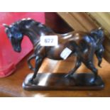 A cast resin horse figurine with bronze effect finish