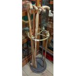A cast iron and brass stick stand - sold with four wooden walking sticks
