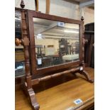A stained wood framed swing dressing table mirror with slender turned supports