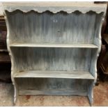 A painted wood two shelf open plate rack with decorative top and sides - wear