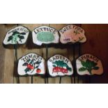A set of six modern cast metal painted vegetable labels