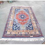 A modern Indian handmade rug with large central medallion and wide border