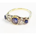 An 18ct. gold three stone sapphire and two diamond ring - shank thin