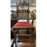 A pair of Victorian carved oak baronial style standard chairs with grapevine decoration and flanking