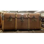 A vintage cane bound and weather coated travelling trunk - sold with another similar - old worm