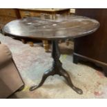 A 70cm 19th Century mahogany tilt-top table, set on turned pillar and tripod base with pad feet -