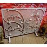 A wrought iron and mesh white painted fire screen