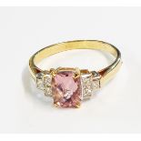 A hallmarked 750 gold Art Deco style ring, set with central oblong morganite and six flanking