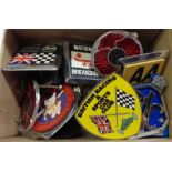 A box containing assorted car badges including British Racing and Sports Car Club, AA, RAC, etc.