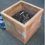 A large terracotta square garden planter - old damage to one base edge