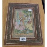 An ornate inlaid framed mid 20th Century Mughal painting, depicting three seated figures in an