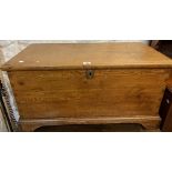 A 90cm Victorian waxed pine lift-top trunk with internal candle box, set on bracket feet -
