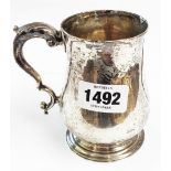 A late Georgian silver baluster shaped christening mug with 1817 and M initial to cartouche and base