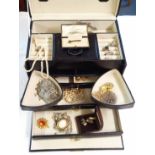 A modern vanity case containing a cultured pearl necklace, boxed garnet cluster bar brooch, silver