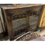 A 98cm polished oak book cabinet with shelves enclosed by a pair of leaded glazed panel doors - 2