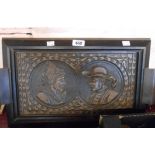 A carved wood tea tray with carved Breton style portrait panels