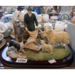 A Leonardo resin figure group depicting a farmer feeding the sheep