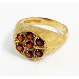 A 9ct. gold garnet cluster ring with textured finish