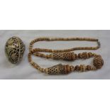 An Oriental carved bone necklace - sold with a lacquer egg