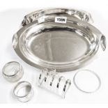 A small silver mitre shaped toast rack, napkin ring, silver topped glass pot and 900 grade