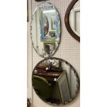 Two vintage frameless wall mirrors comprising one oval and one circular, both with facet cut