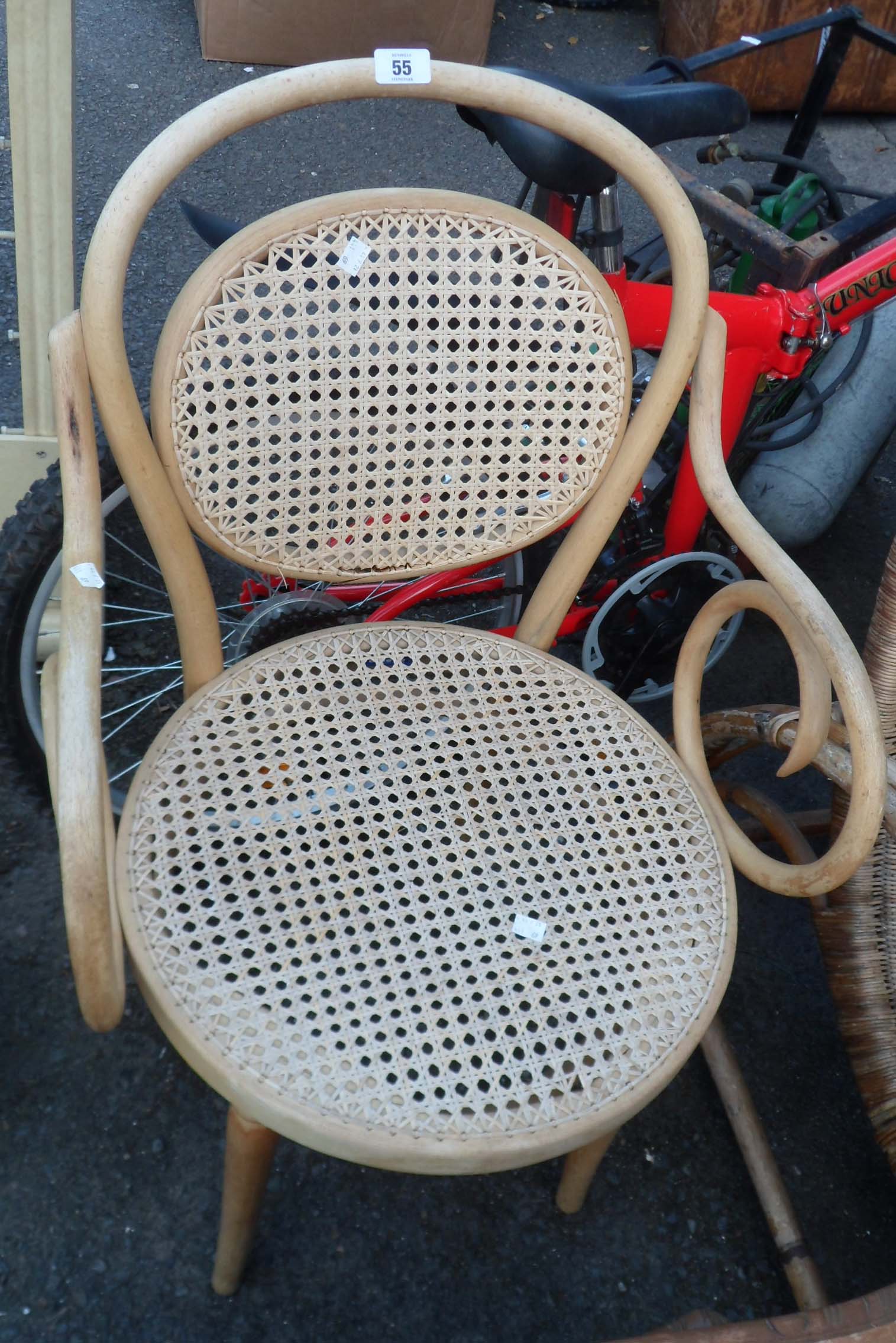 A bentwood elbow chair with rattan back and seat set on tapered legs