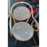 A bentwood elbow chair with rattan back and seat set on tapered legs
