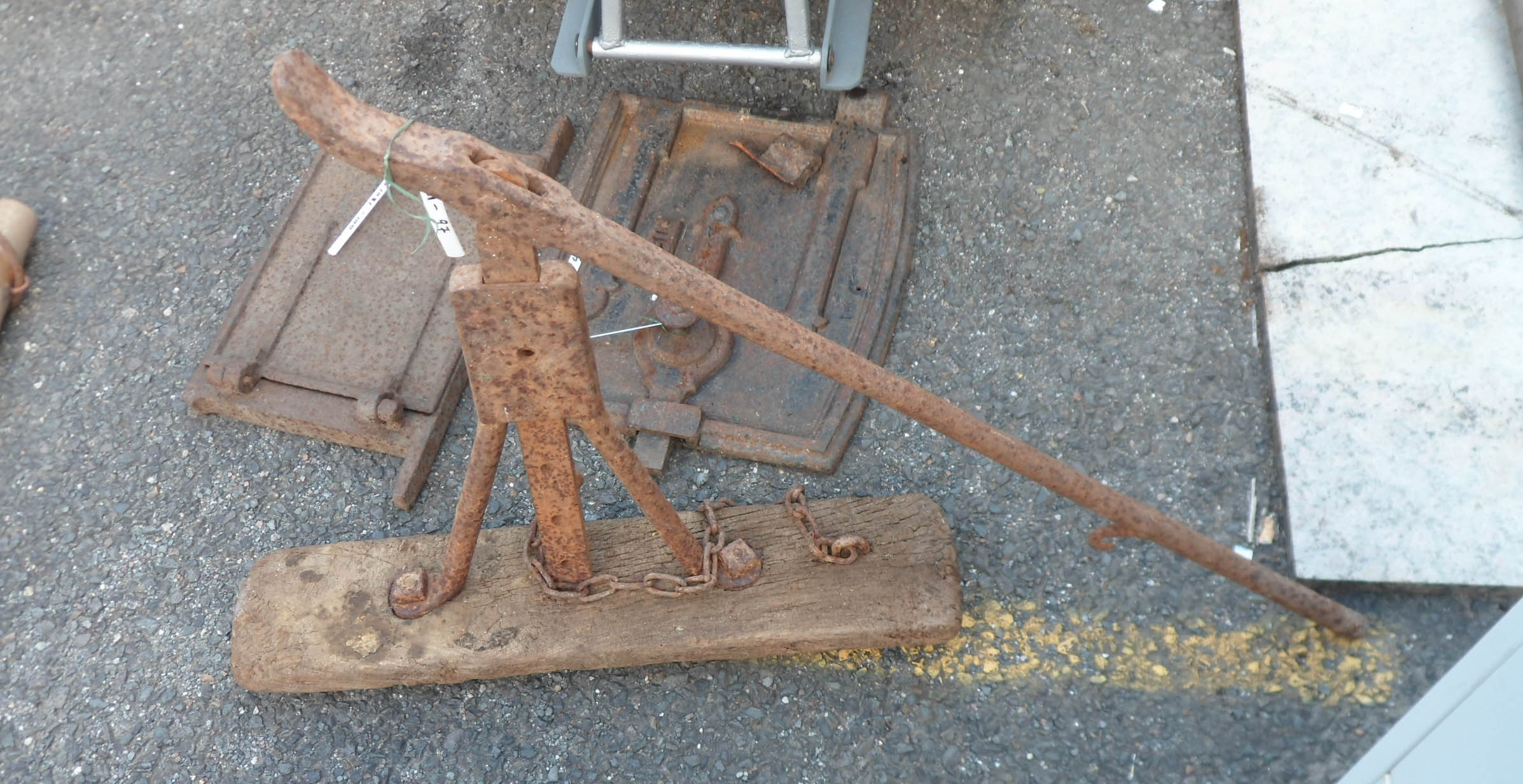 An antique iron and wood cart jack