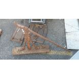 An antique iron and wood cart jack