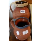 Two slip decorated terracotta milk jugs - various condition