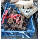 A crate of assorted tools including drill grinding jig, clamps, small vices, etc.