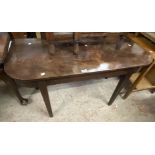 A 1.16m 19th Century stained mahogany demi-lune side table, set on square tapered legs