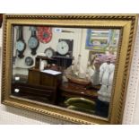 An old gilt framed bevelled oblong wall mirror with decorative beaded border