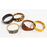 Four assorted rings including a 22ct. gold wedding band, etc.